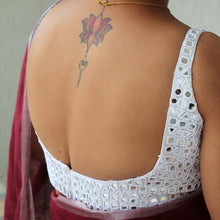 Close-up of hand-done Kutch mirror embroidery on white cotton silk