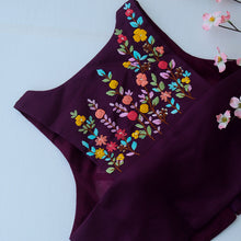 Sleeveless wine halter neck blouse styled with a saree