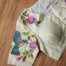Model wearing beige hand-painted tussar silk blouse with saree